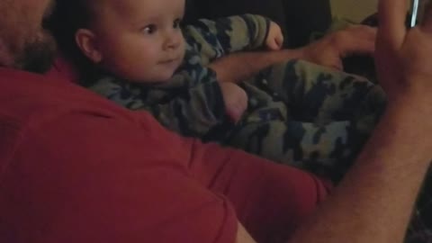 Baby finds his own video funny