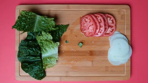 A Man Cutting Vegetables With A Knife