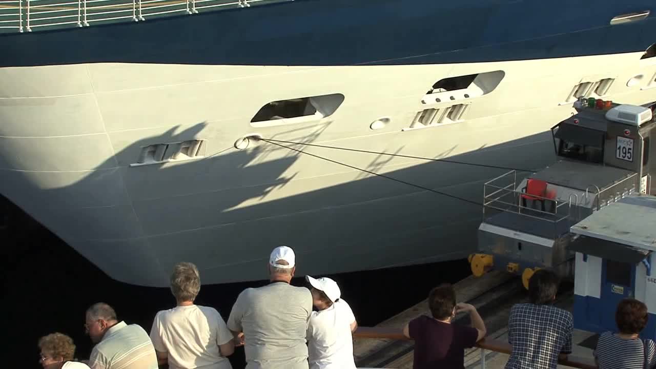 Passengers watch a ship in Gatun locks