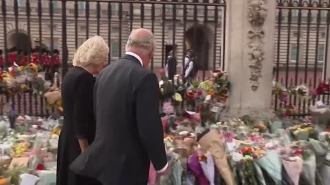 King Charles wipes away tears as he returns to Buckingham Palace greeted by mourners