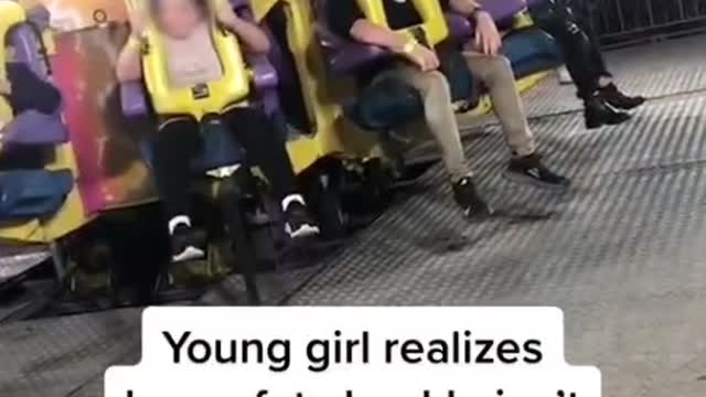 Young girl realizes her safety buckle isn't latched on fair ride