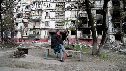 Mariupol woman sits unflinching while shells explode