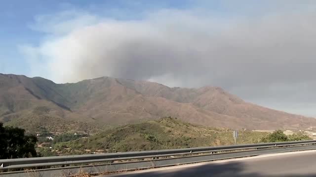 People take selfie near Spanish wildfire