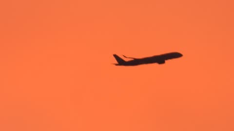 Passenger Airline Flying Through Painted Toxic Orange Sky Aug.4, 2024