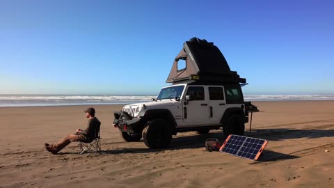 A person camping by the sea, with the beauty of nature nearby