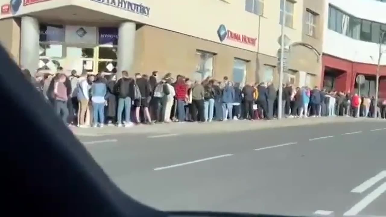 A huge line of Ukrainian refugees at the passport office in Prague. See description for more info