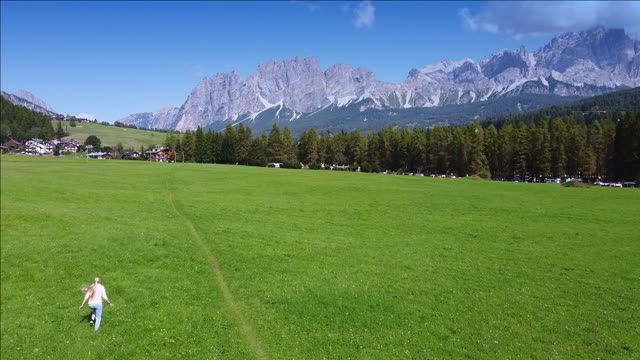 woman having fun on valley with beautiful scenery in italy