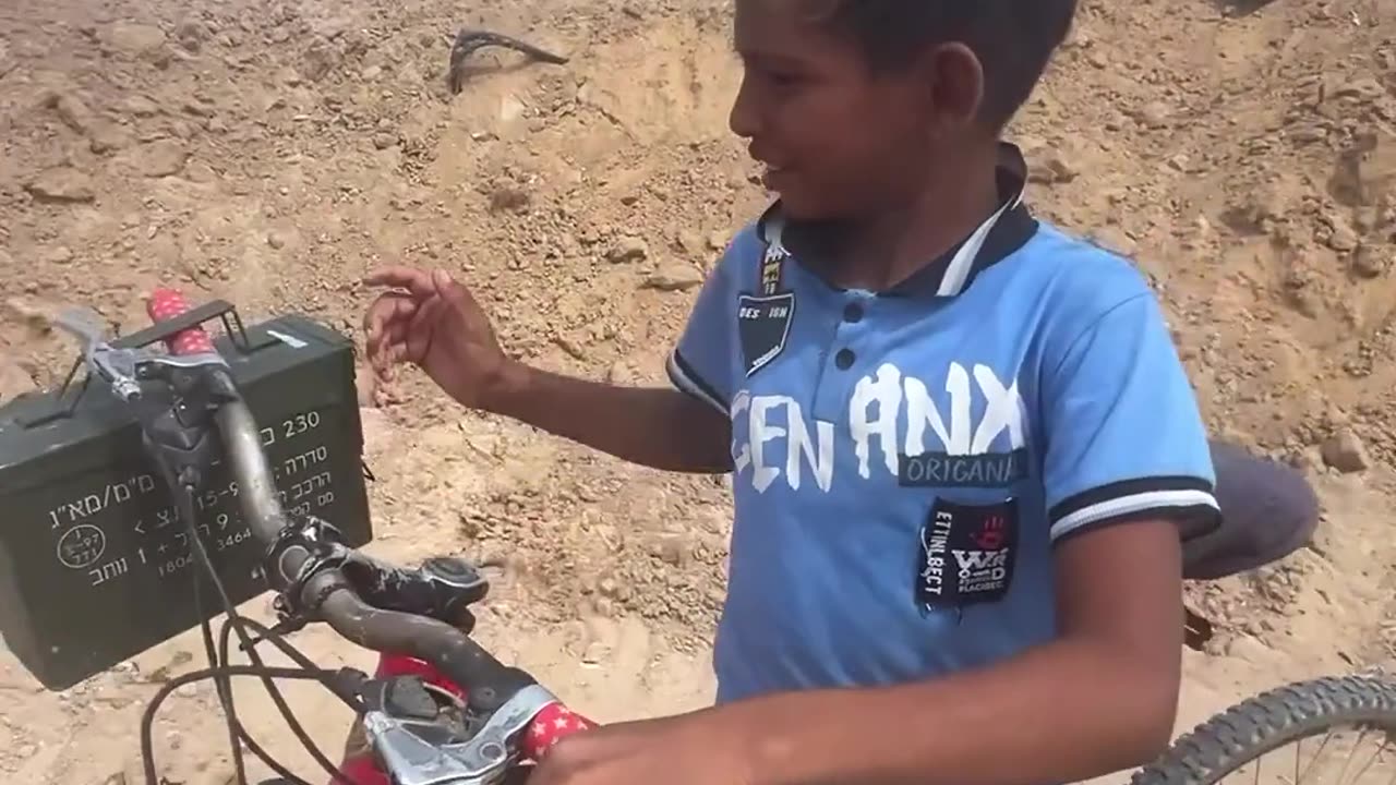 A young Palestinian boy keeps his belongings in a metal box left behind by the Israeli forces