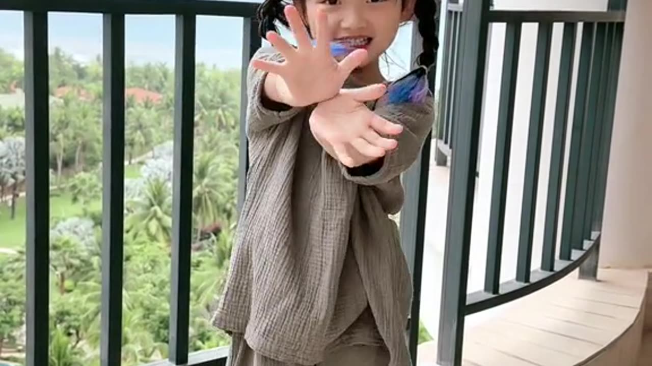 Very cute baby jumping on the balcony