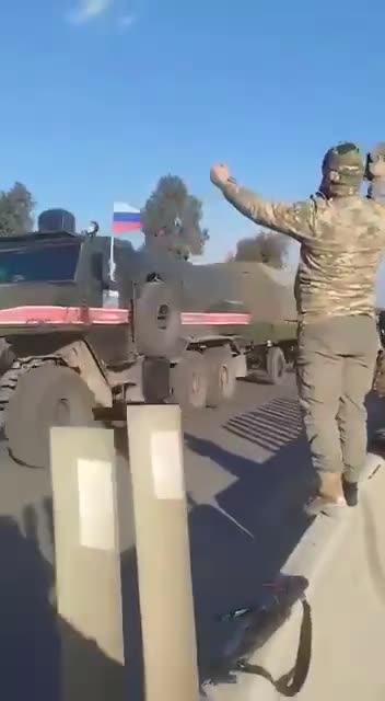 Syrian Fighters Wave Shoes At Russians as They Head For Turkey