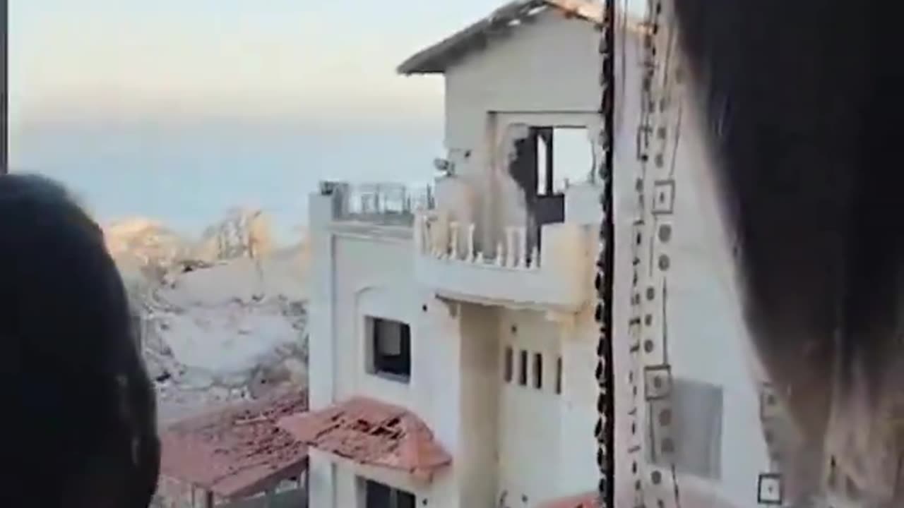 Israeli soldiers throwing pieces of bread at demolished houses in Gaza,