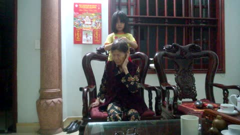 Grandchildren tie the hair for grandmother