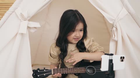 Girl Playing Music in Front of Phone