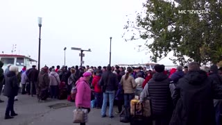 Fleeing civilians in Russian-held Kherson line up to board boats