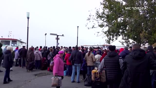 Fleeing civilians in Russian-held Kherson line up to board boats