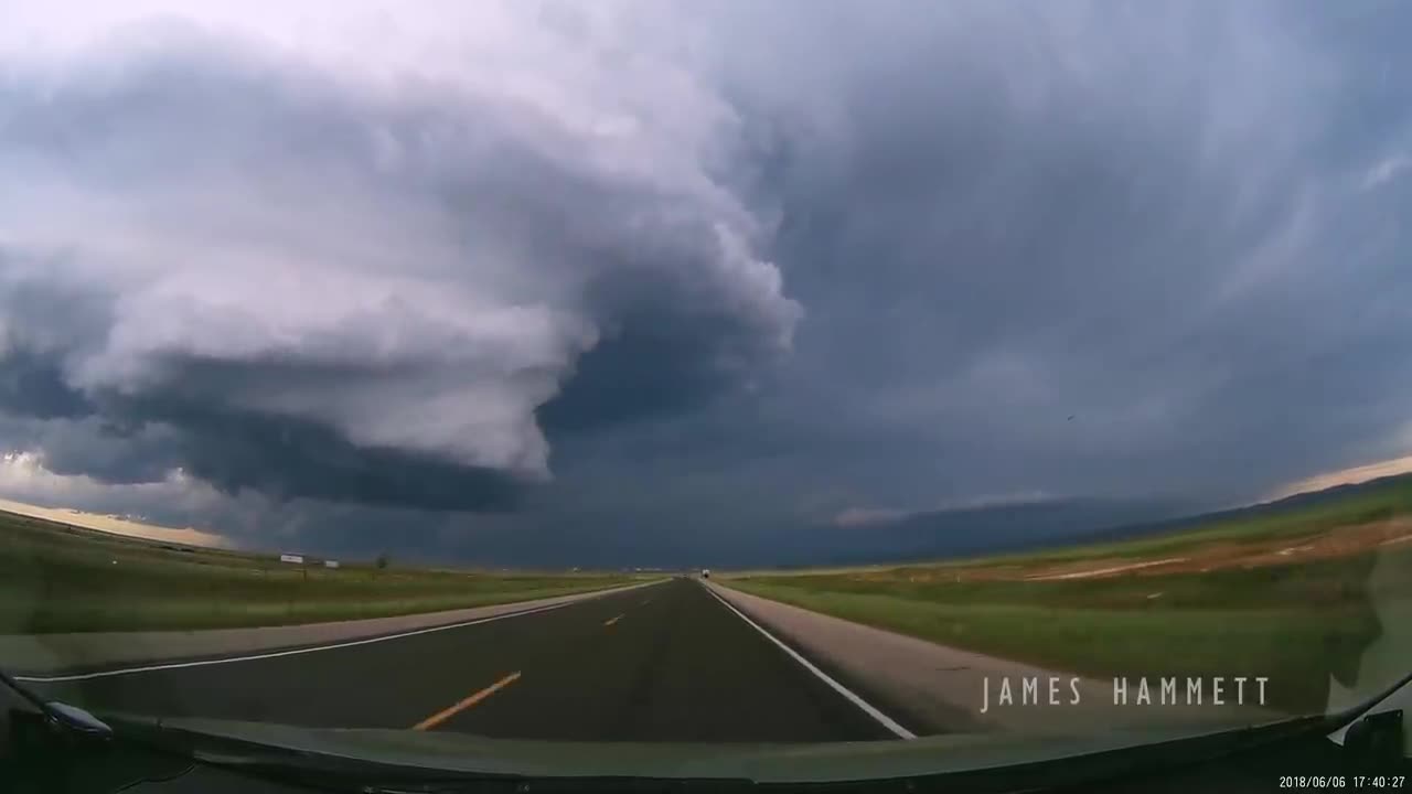 Storm chasing dashcam: Tornado crossing the highway! Laramie, Wyoming