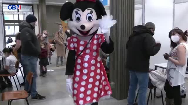 Prague Czech Republic - Disney characters greeting children & rewarding them with Candy after getting their Vaccine