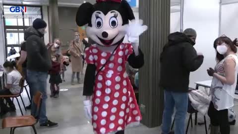 Prague Czech Republic - Disney characters greeting children & rewarding them with Candy after getting their Vaccine