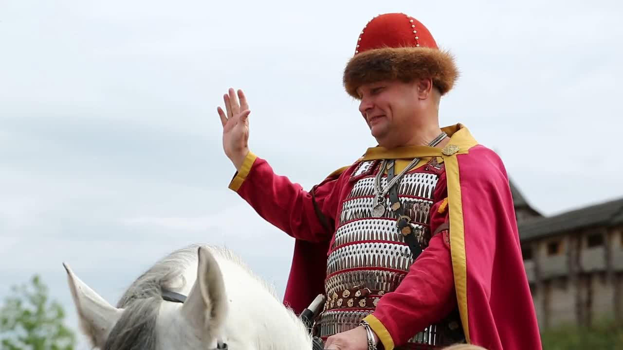 Ancient warrior in armours on white horse in Kyivan Rus park