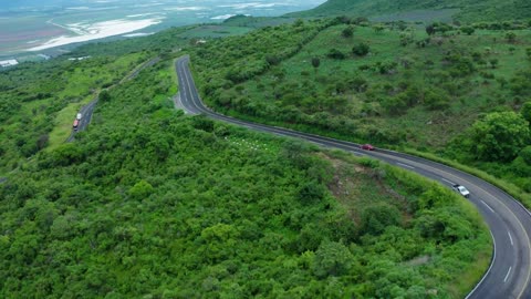 Curvy road on a tree covered hill