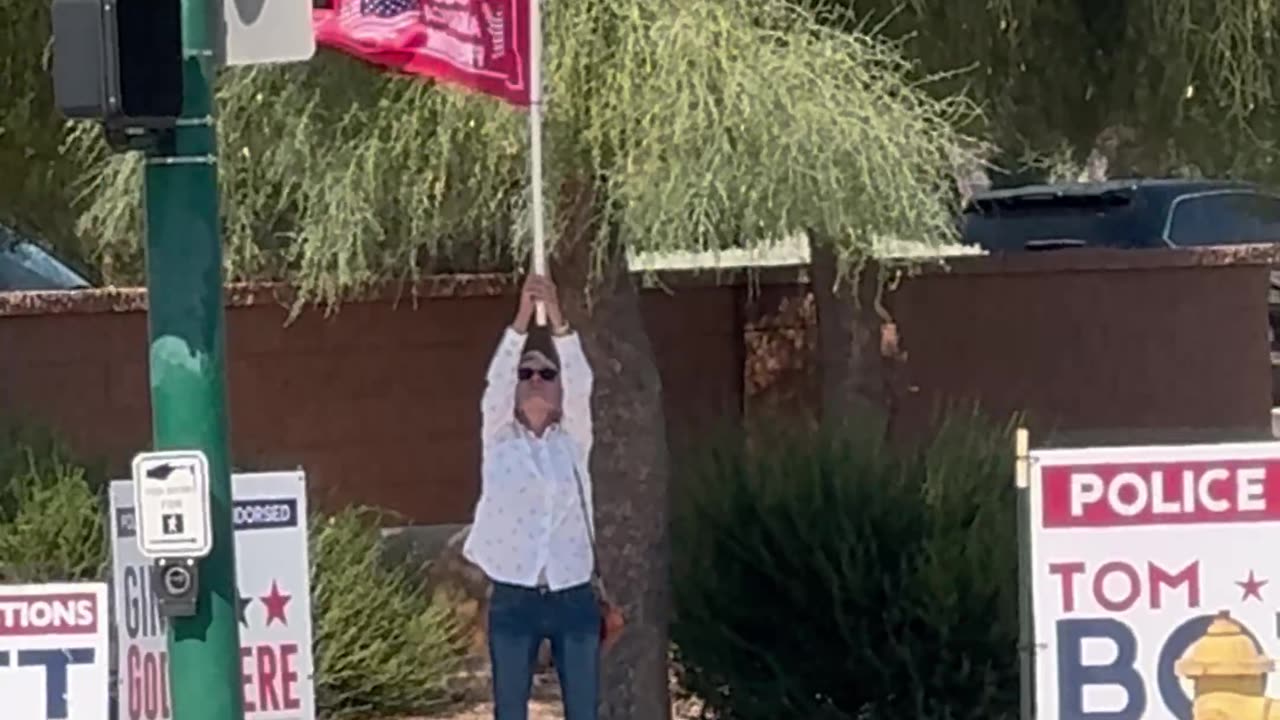 Crazy orange cult moron standing in 110 degree heat