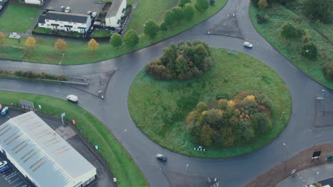 Aerial Shot Of Cars Movement In A Roundabout Road