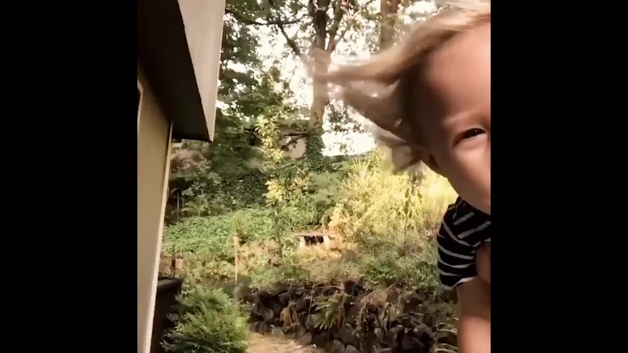 Little baby playing with the sweeping robot