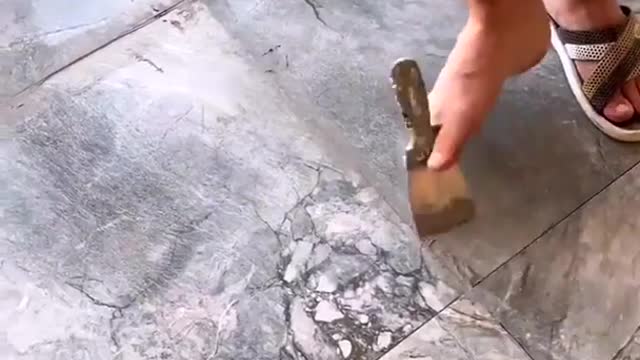 Armless Man tiles a floor with just his feet