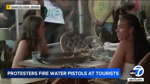 Barcelona anti-tourism protesters fire water pistols at visitors