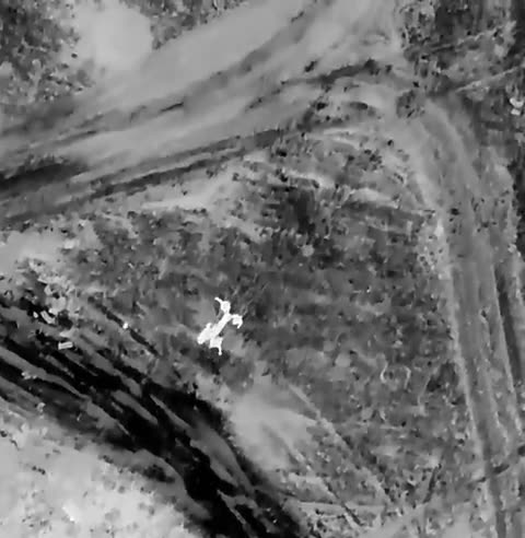 Ukrainian drone attacks Russians evacuating a wounded. Thermal video.