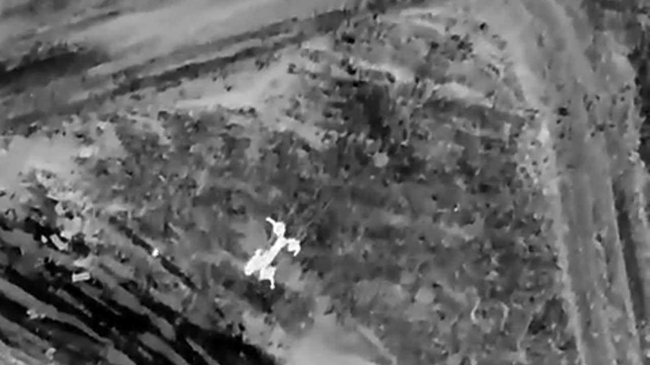 Ukrainian drone attacks Russians evacuating a wounded. Thermal video.