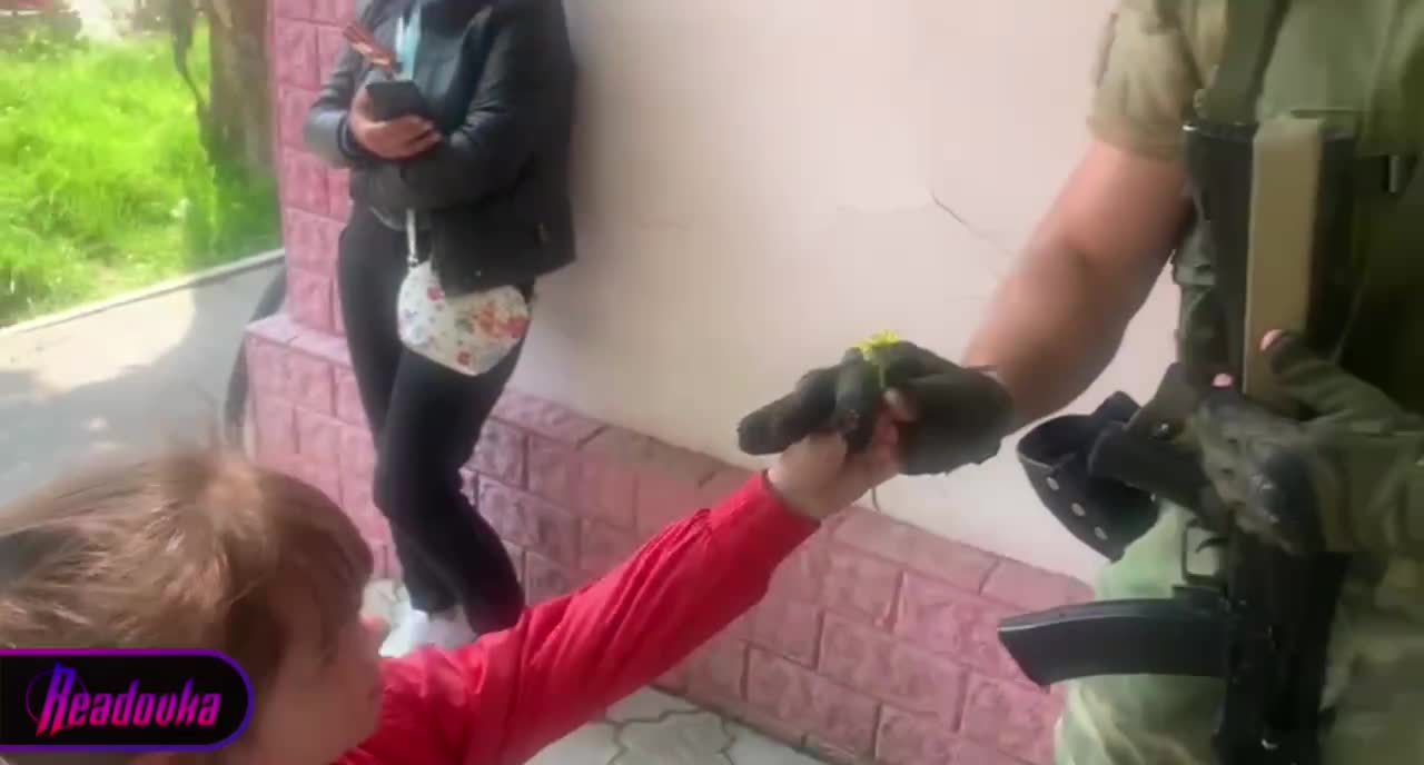 Girl thanked a Russian soldier by giving him a flower.