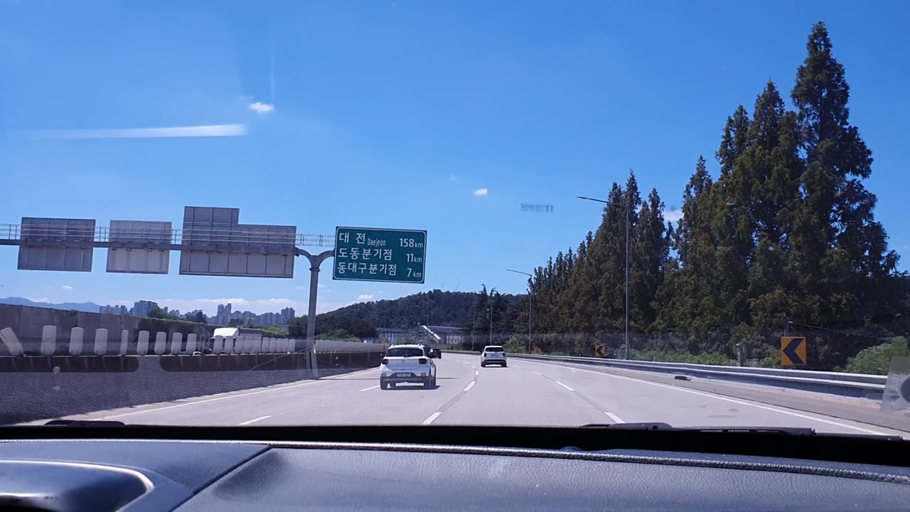 the front view of a car driving on a highway