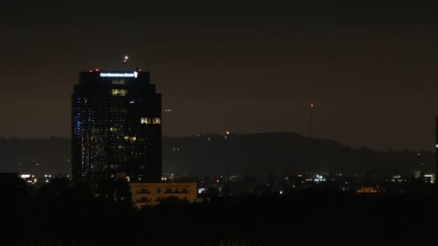 Los Angeles A Building At Night With An Airplane