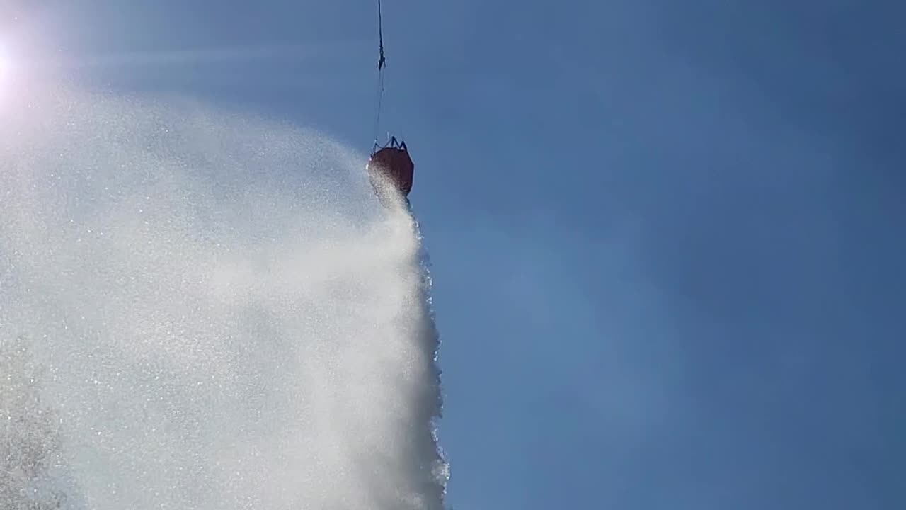 Helicopter dropping water on the Ross Fork Fire