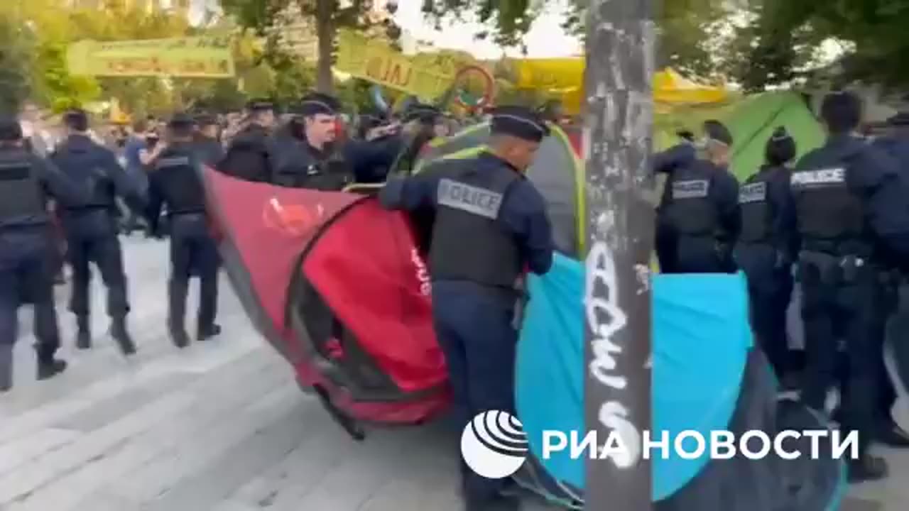 Police disperse a migrant tent city in central Paris.