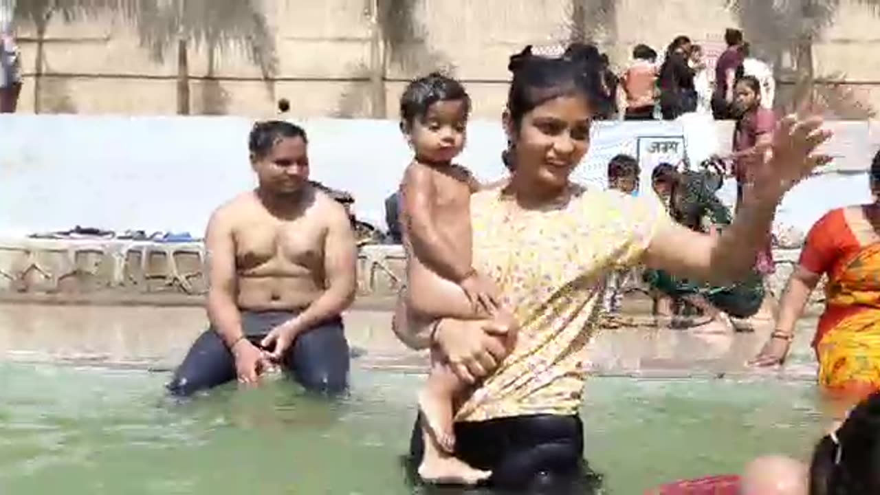 Baby swimming with family