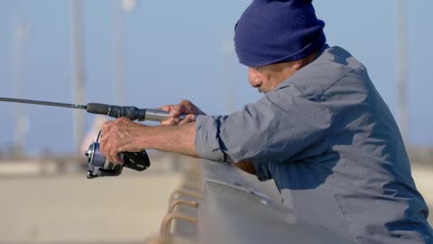 Man Reeling in Fishing Line