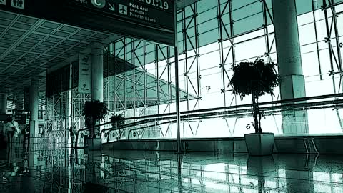 People walking down an airport corridor in fast motion