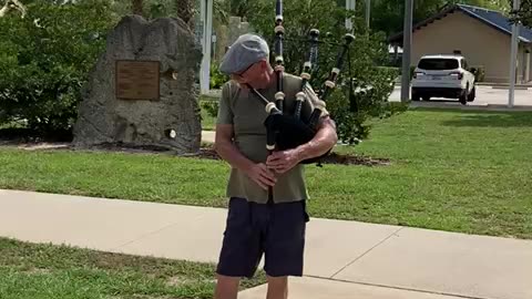 Retired police officer from the Bronx plays the Bagpipe on Flag Day