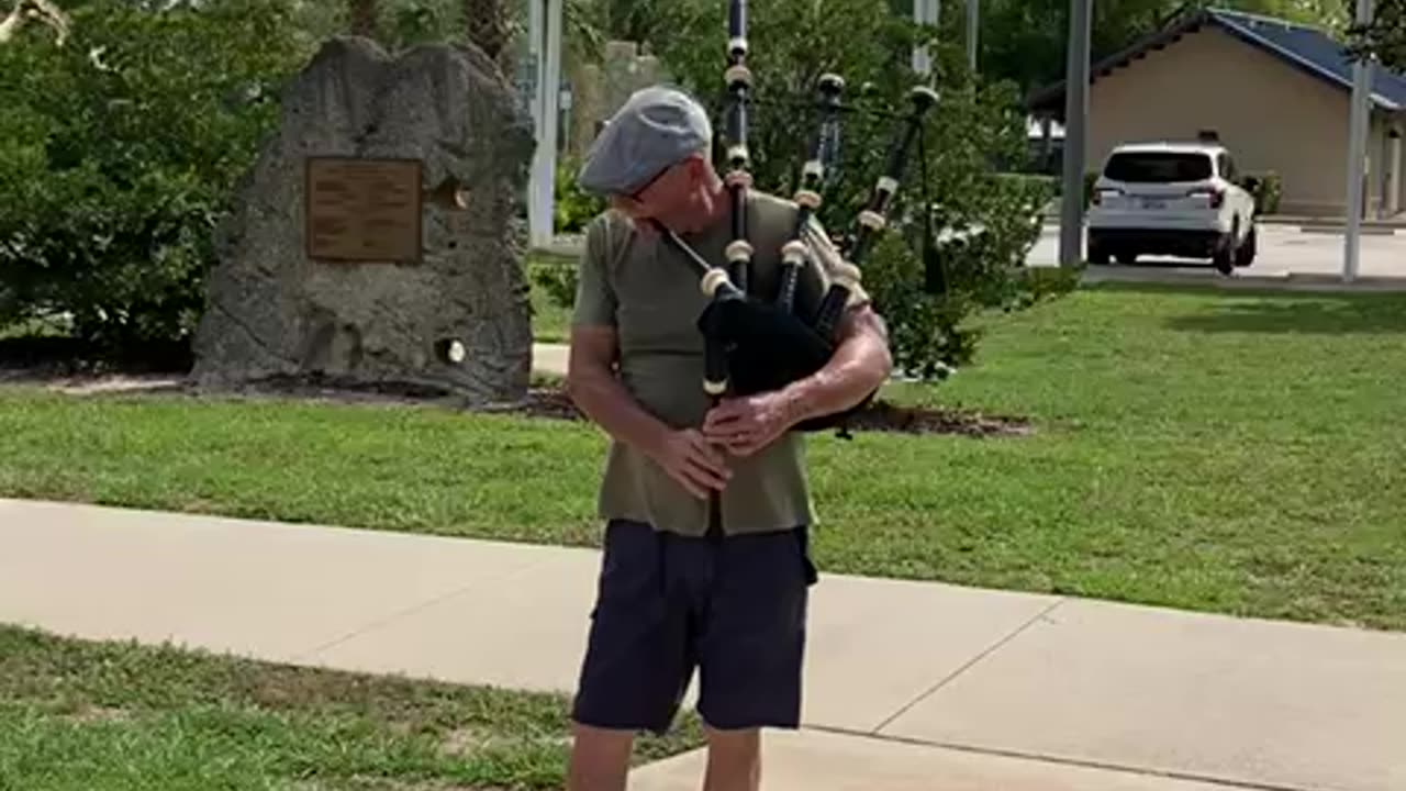Retired police officer from the Bronx plays the Bagpipe on Flag Day