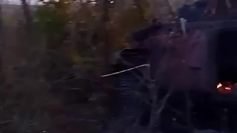 Footage of Russian Soldiers Sifting Through a Burning Vehicle