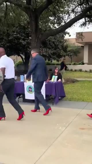 Grown men march around in red high heels to protest male violence against women