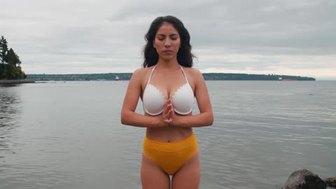 HOT WOMAN WEARING BIKINI MEDITATING