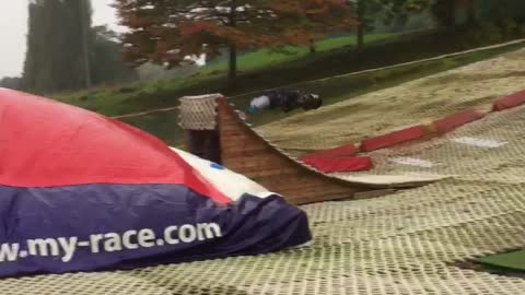 Guy slides down man made ski ramp lands on red blob