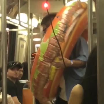 Guy with donut hamburger blow up toy subway