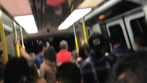 People in crowded subway cheer louis