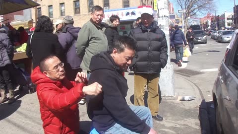 Luodong Briefly Massages Chinese Man In Black Hoodie On Sidewalk