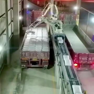 Robots that load bags in a factory.