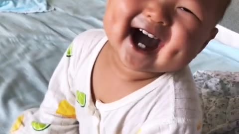 adorable baby making a lot of laugh